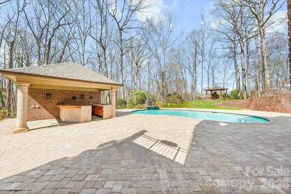 a view of a house with backyard porch and sitting area