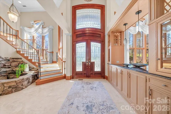 a view of a kitchen with kitchen island granite countertop a refrigerator and a stove