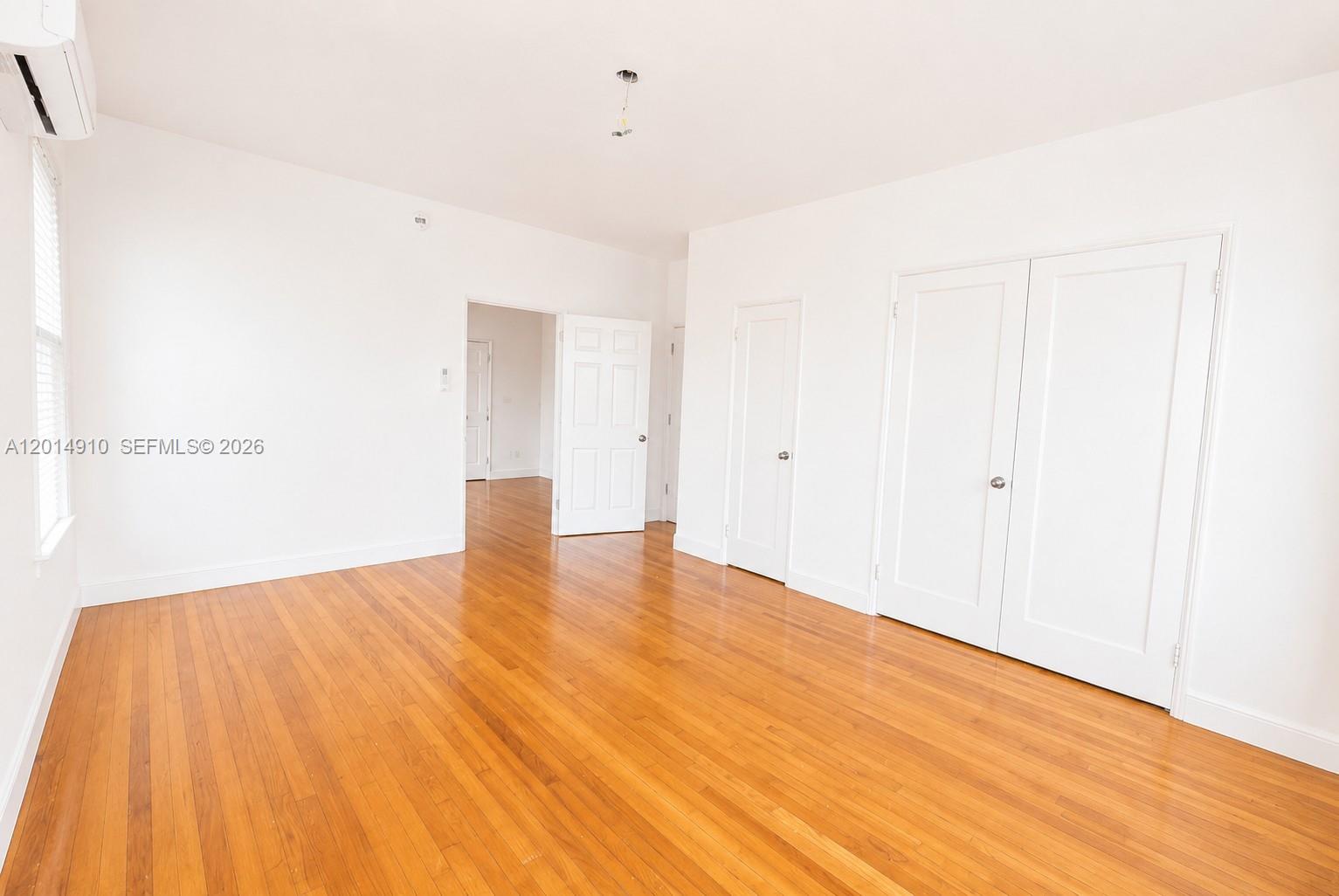 7936 Harding Avenue, Unit 1 Miami Beach, FL 33141 - Photo 6 of 7 a view of empty room with wooden floor