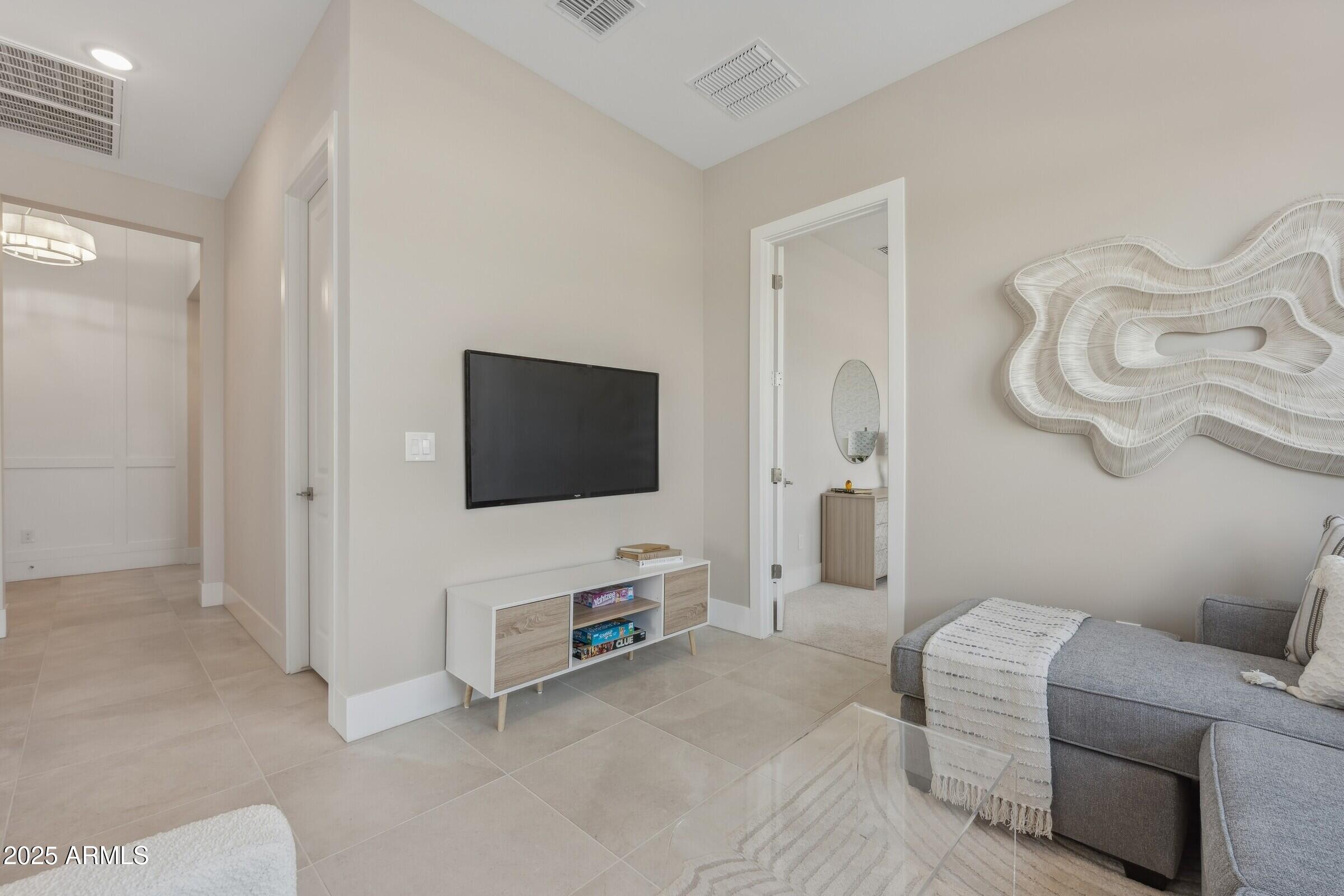 621 East Grayling Road San Tan Valley, AZ 85140 - Photo 19 of 33 a living room with furniture a flat screen tv and a white door