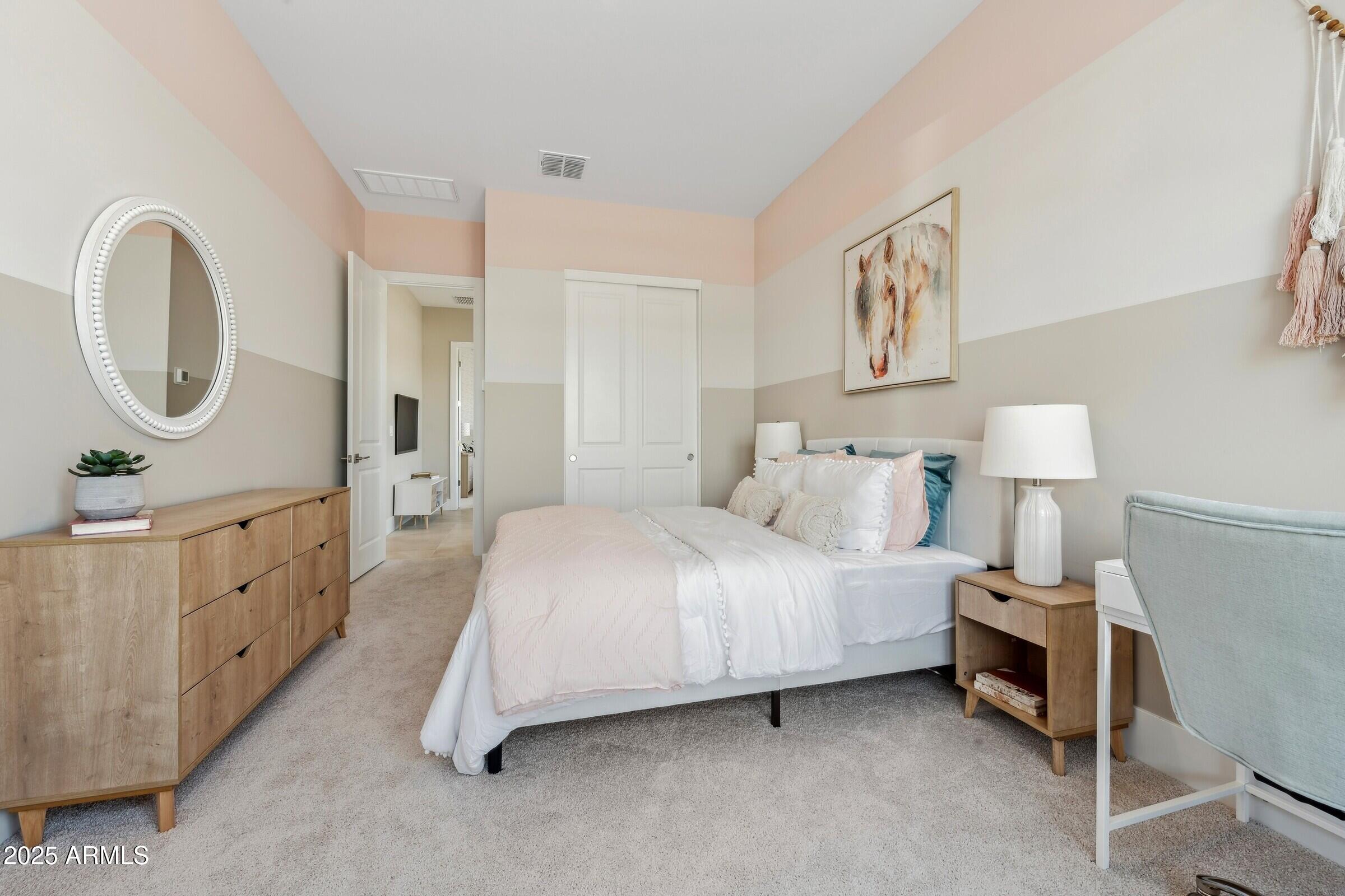 621 East Grayling Road San Tan Valley, AZ 85140 - Photo 21 of 33 a spacious bedroom with a bed a mirror and lamp