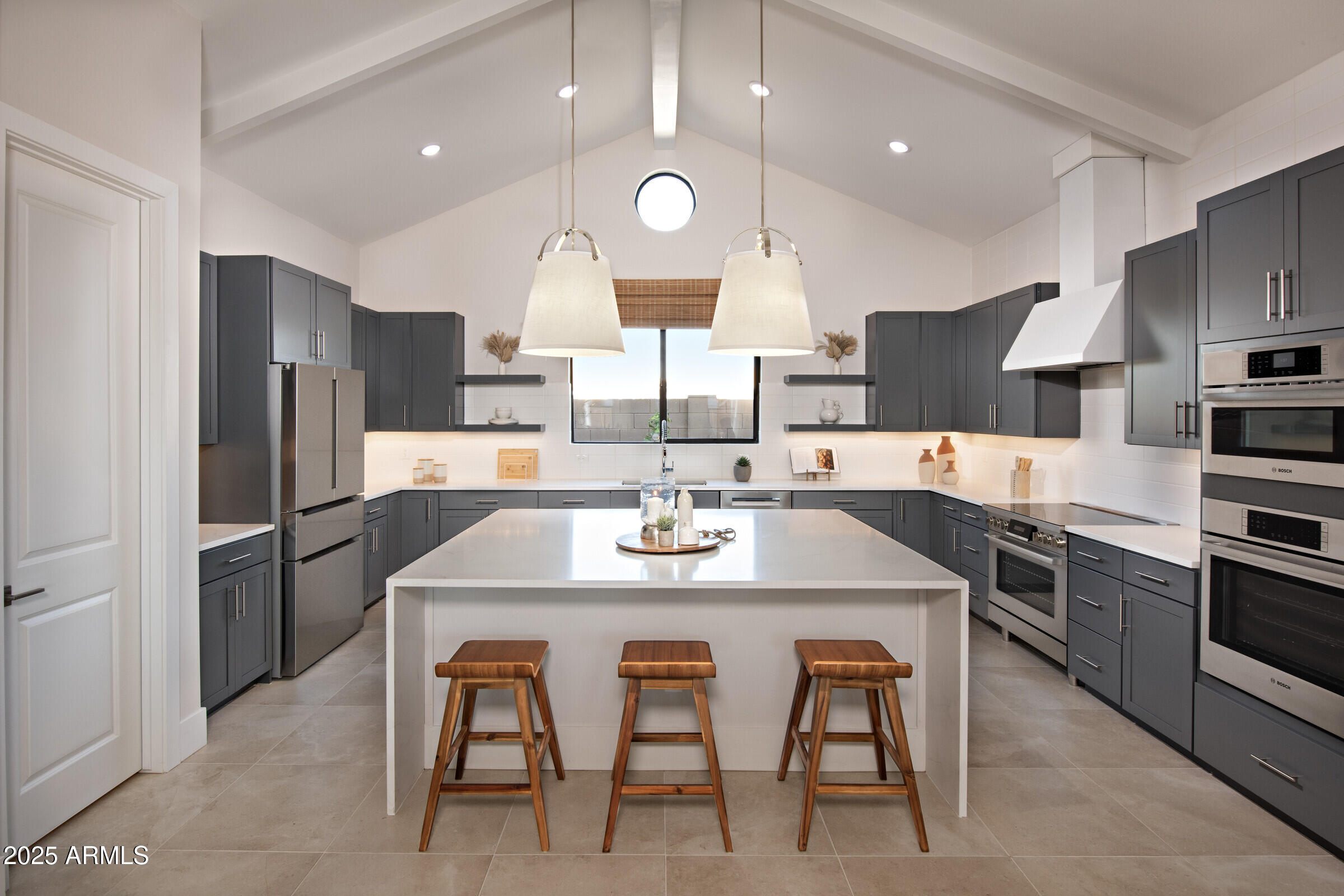 621 East Grayling Road San Tan Valley, AZ 85140 - Photo 2 of 33 a large kitchen with a table chairs refrigerator and microwave