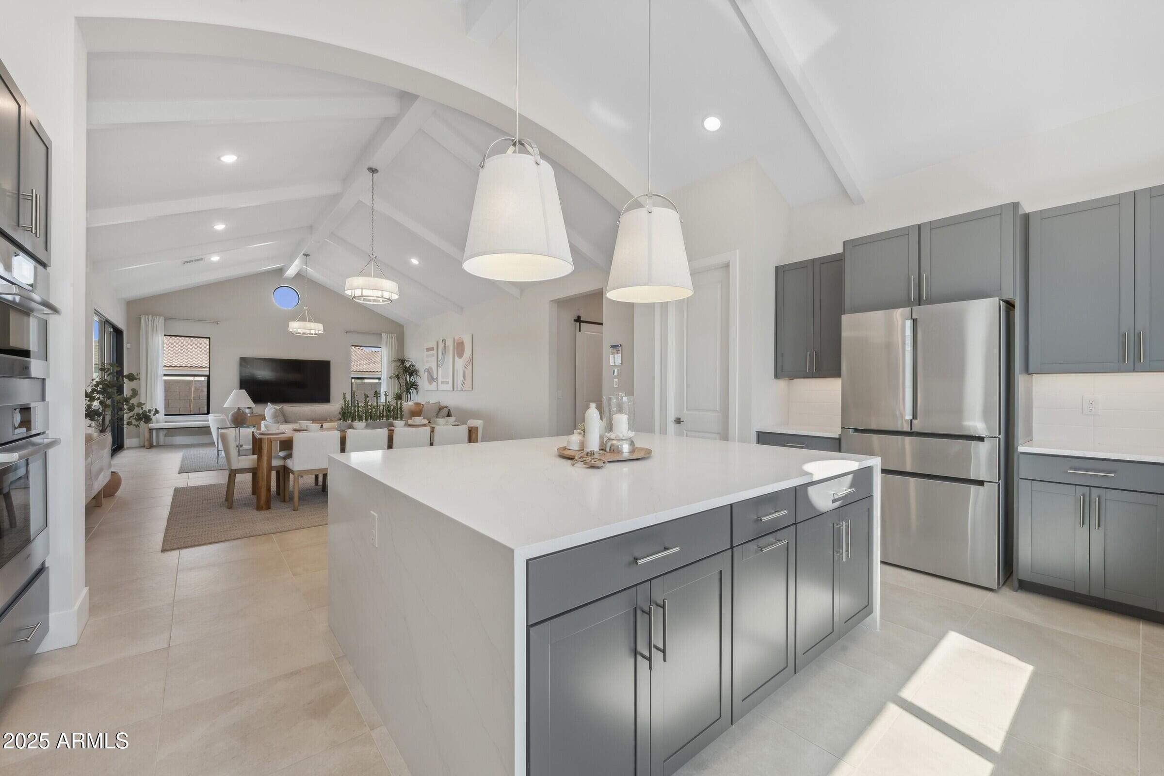 621 East Grayling Road San Tan Valley, AZ 85140 - Photo 3 of 33 a large kitchen with a large counter top a sink stainless steel appliances and cabinets