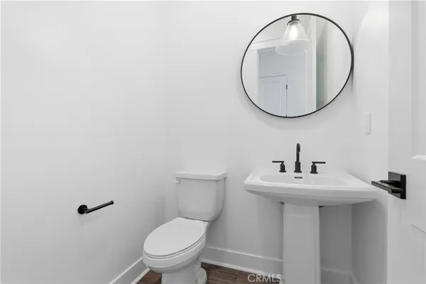 a bathroom with a sink a mirror and a toilet