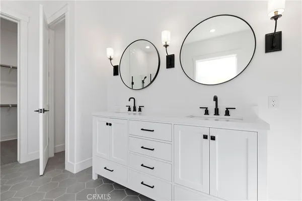 a bathroom with 2 sink and a mirror