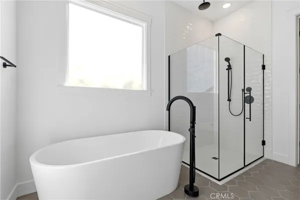 a white bath tub sitting next to a shower