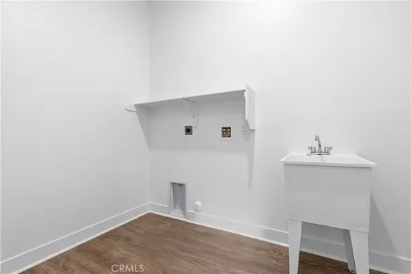 a view of utility room with wooden floor