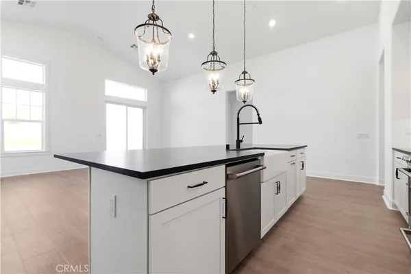 a hallway with sink and wooden floor