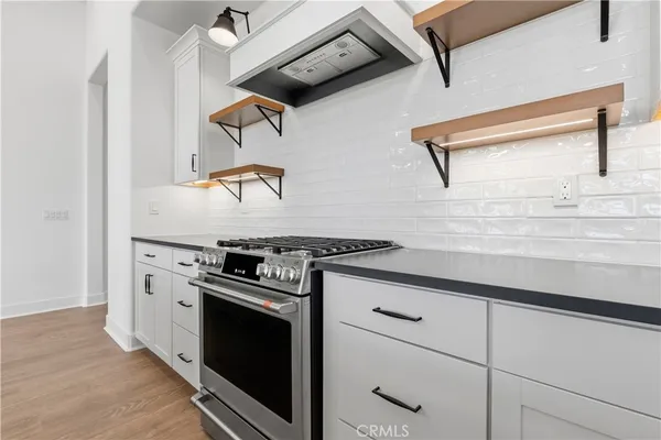 a stove top oven sitting inside of a kitchen