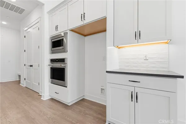 a view of kitchen with stainless steel appliances cabinets and oven