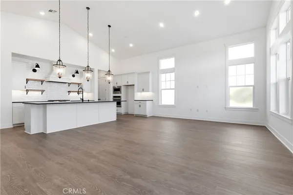 a view of a kitchen with cabinets and wooden floor