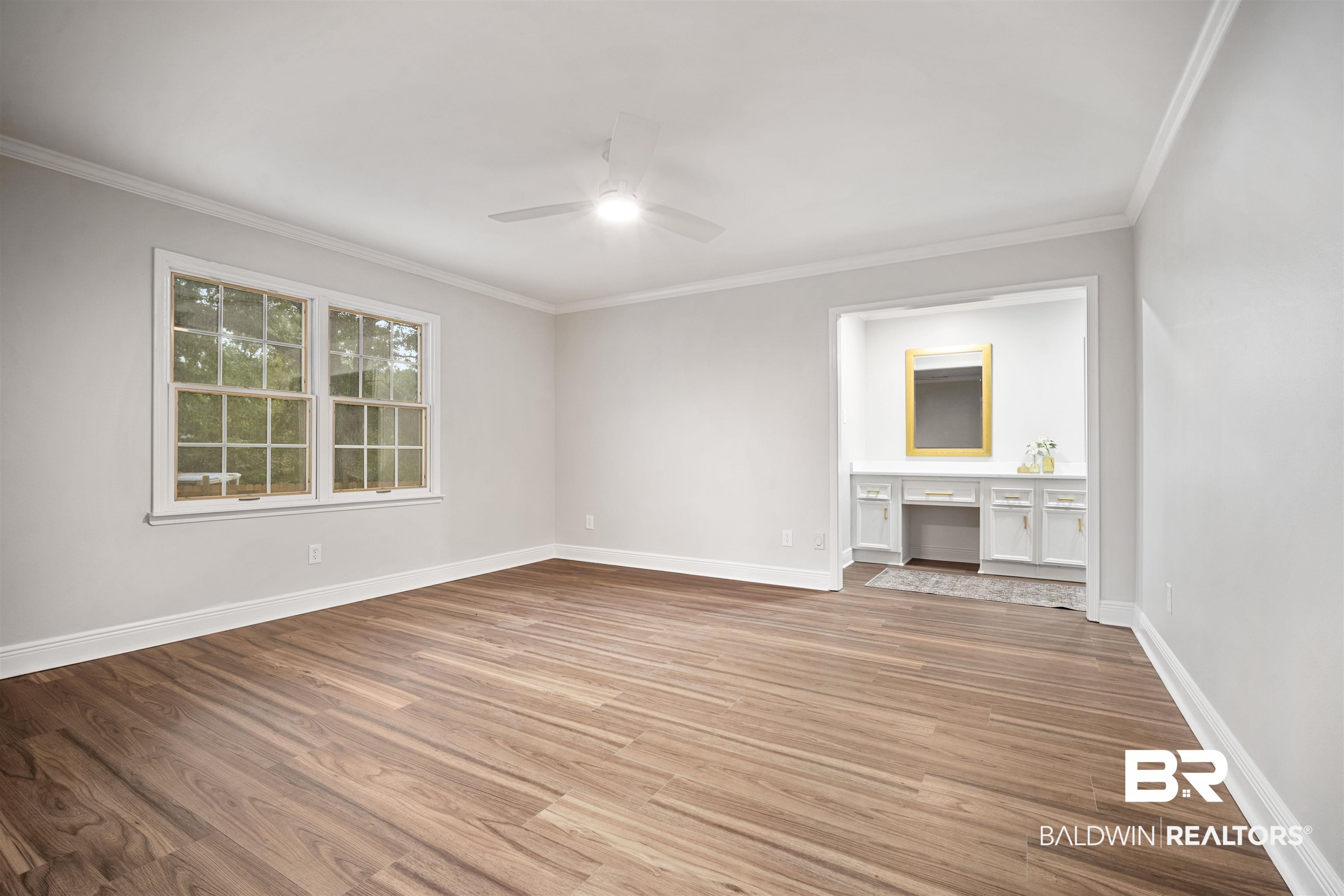 3050 Lacoste Road Mobile, AL 36618 - Photo 13 of 30 Unfurnished living room featuring crown molding, light wood-style floors, built in study area, and ceiling fan