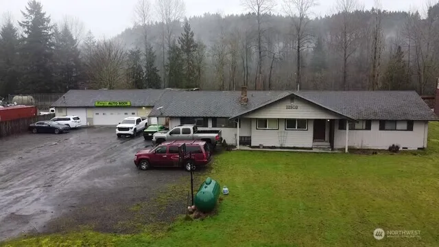 a backyard of a house with table and chairs