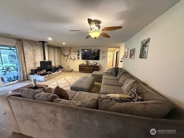 a living room with furniture and a ceiling fan