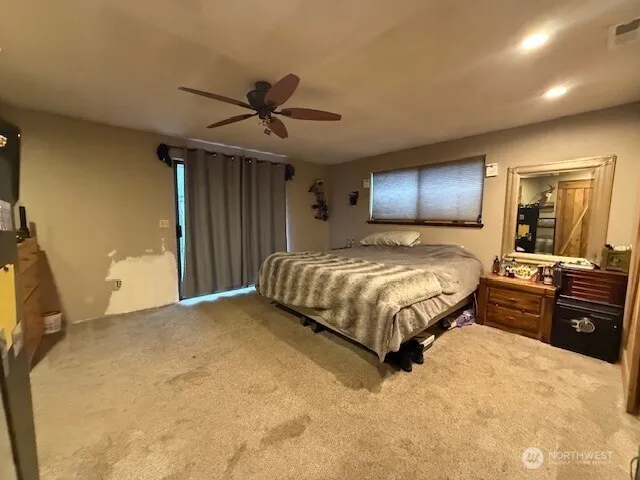 a large bed sitting in a bedroom next to a bathroom