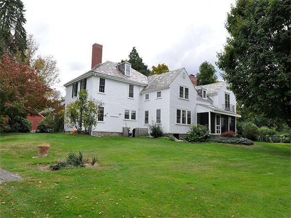 435 High Street Walpole, MA 02081 - Photo 2 of 24 a house that is sitting in the grass with large trees and plants