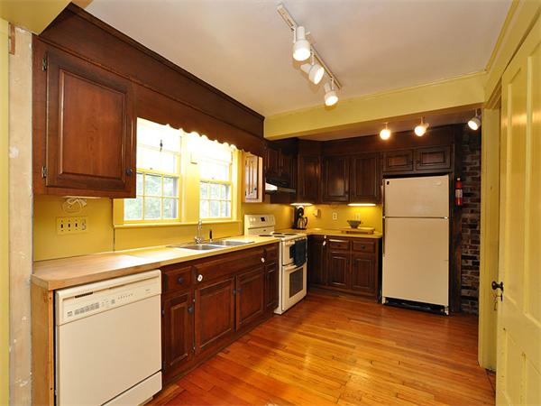 435 High Street Walpole, MA 02081 - Photo 4 of 24 a kitchen with a sink a stove a refrigerator and black cabinets