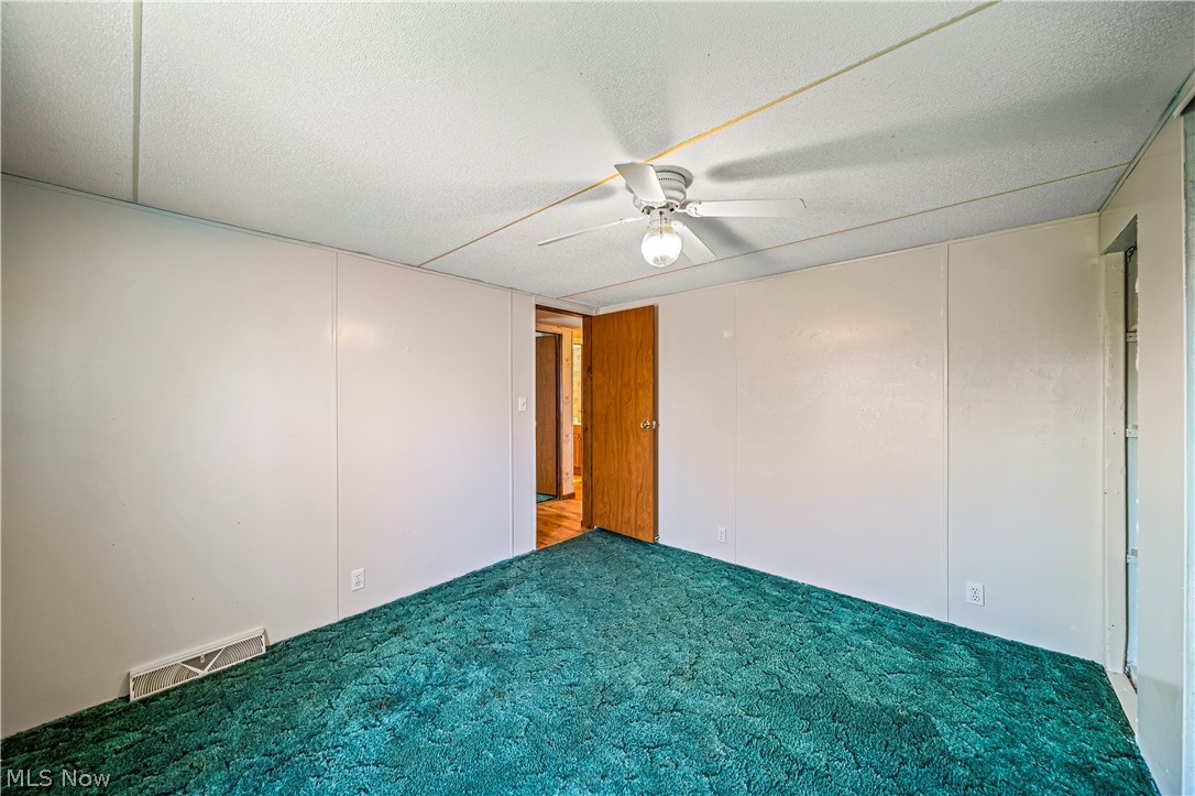 3471 Fox Road Kingsville, OH 44048 - Photo 25 of 50 Carpeted spare room with ceiling fan