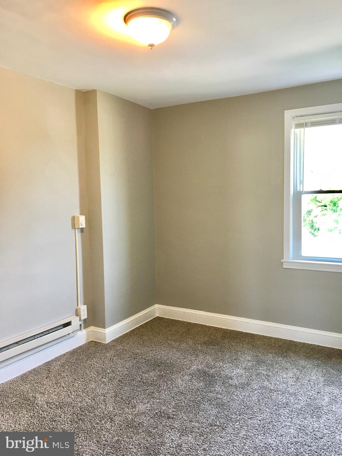 7235 Holabird Avenue, Unit B Dundalk, MD 21222 - Photo 11 of 15 an empty room with a window