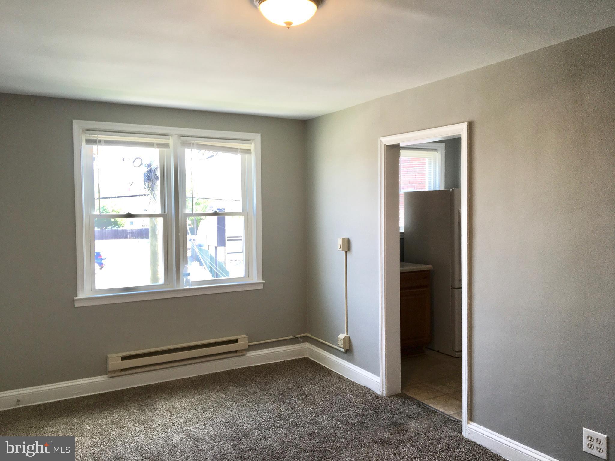 7235 Holabird Avenue, Unit B Dundalk, MD 21222 - Photo 14 of 15 an empty room with windows