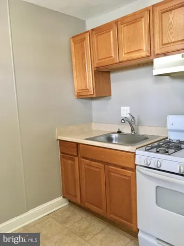 a kitchen with stainless steel appliances granite countertop a sink and a stove
