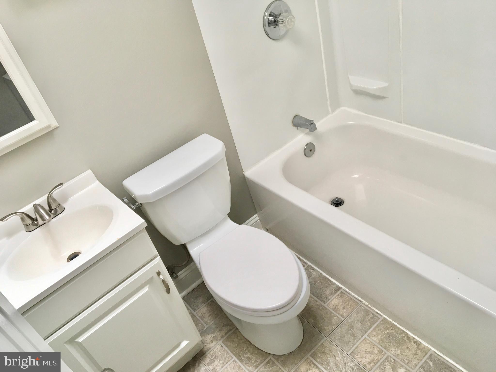 7235 Holabird Avenue, Unit B Dundalk, MD 21222 - Photo 7 of 15 a white toilet sitting next to a bath tub