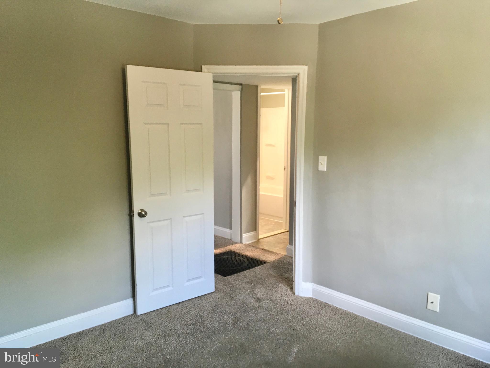 7235 Holabird Avenue, Unit B Dundalk, MD 21222 - Photo 8 of 15 an empty room with windows