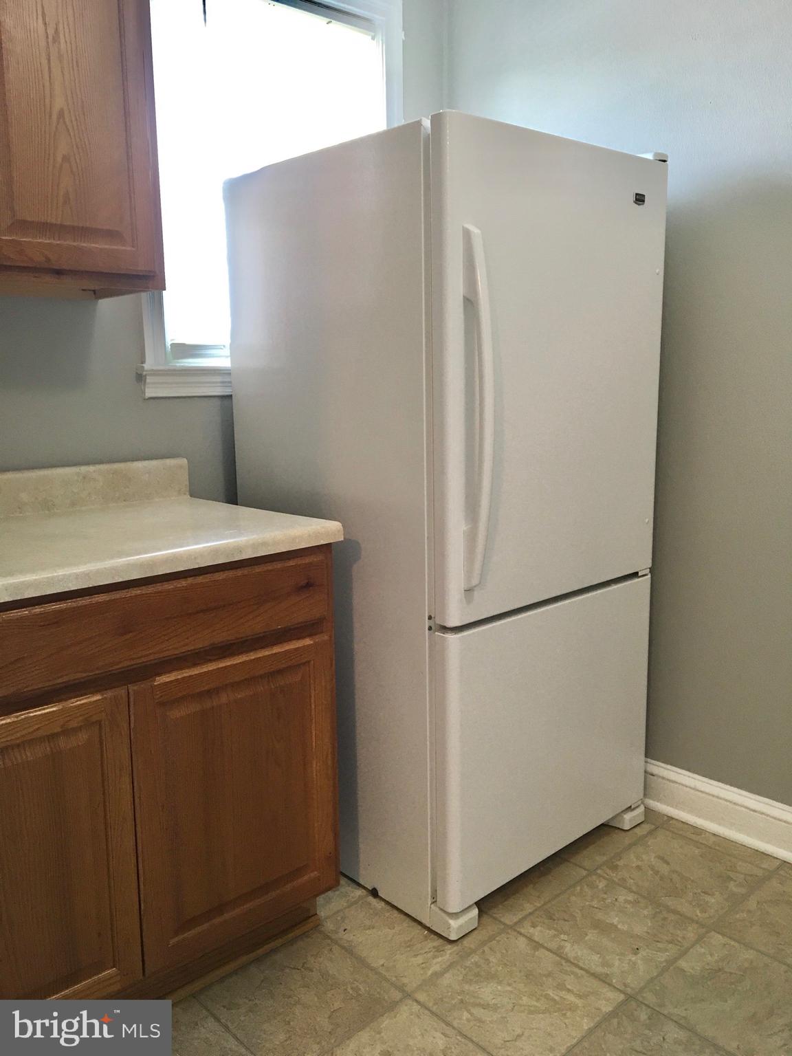 7235 Holabird Avenue, Unit B Dundalk, MD 21222 - Photo 9 of 15 a white refrigerator freezer sitting in a kitchen