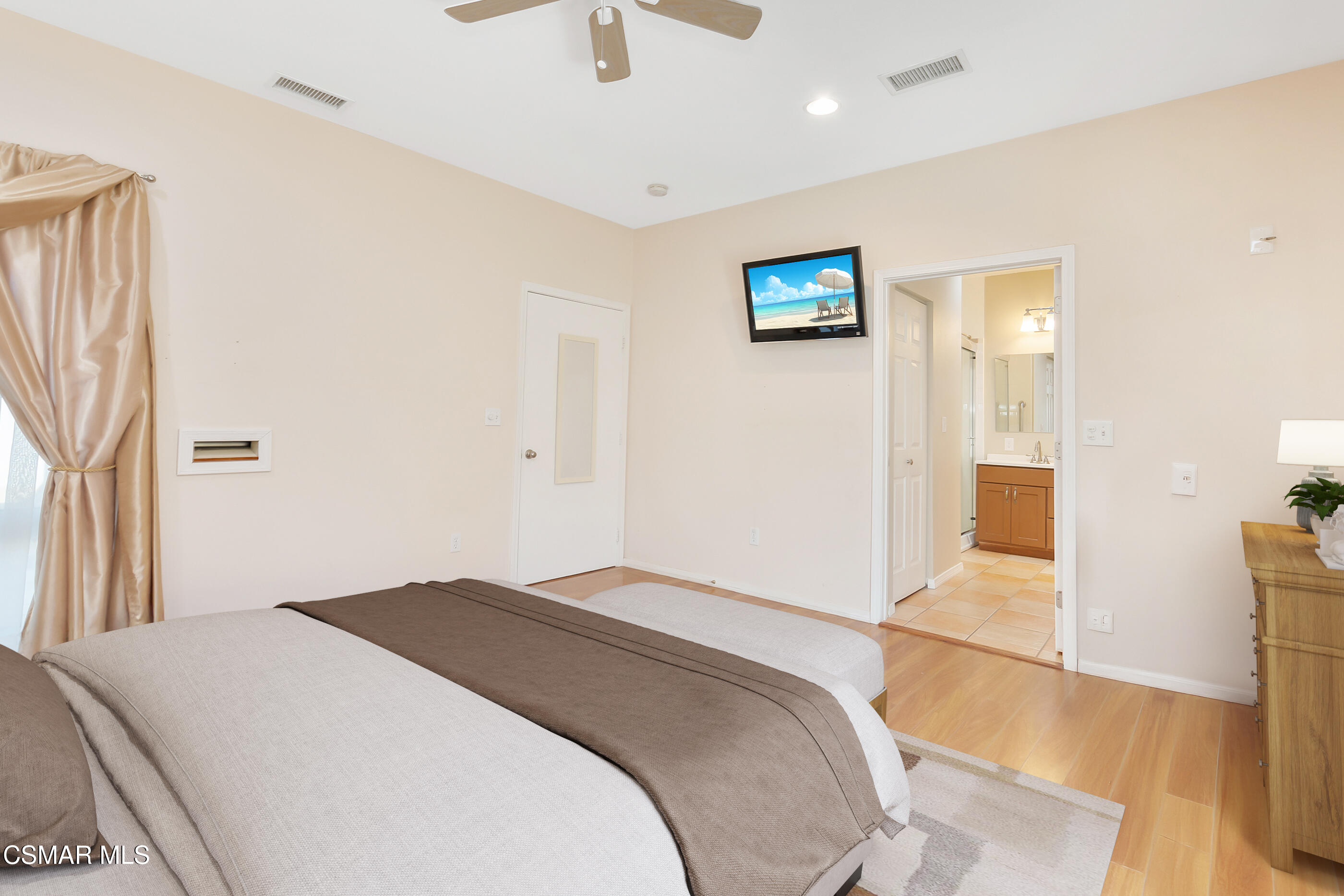 1204 Deodar Avenue Oxnard, CA 93030 - Photo 18 of 25 a bedroom with a large bed and a chandelier