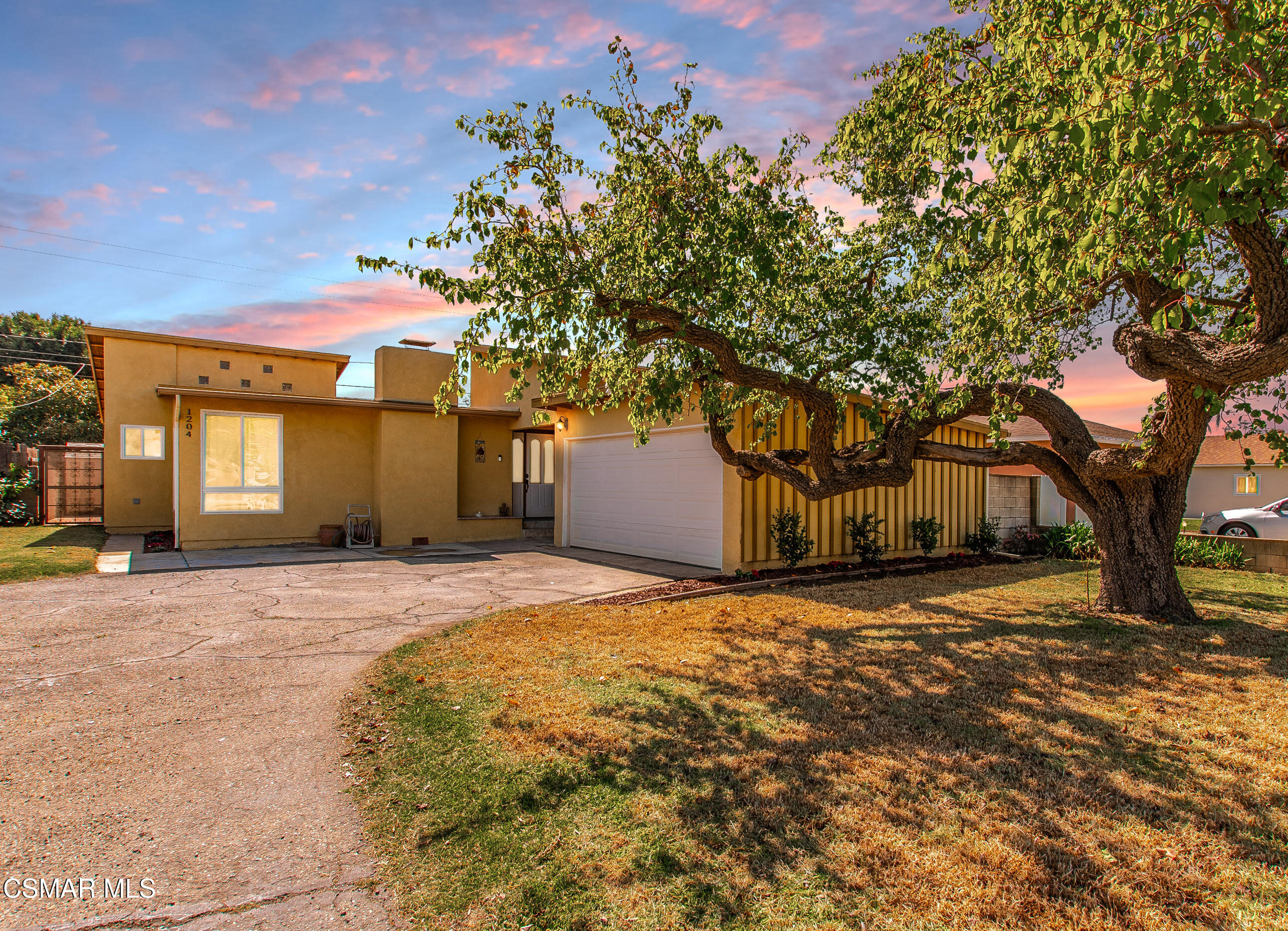 1204 Deodar Avenue Oxnard, CA 93030 - Photo 25 of 25 a front view of a house with a yard and garage