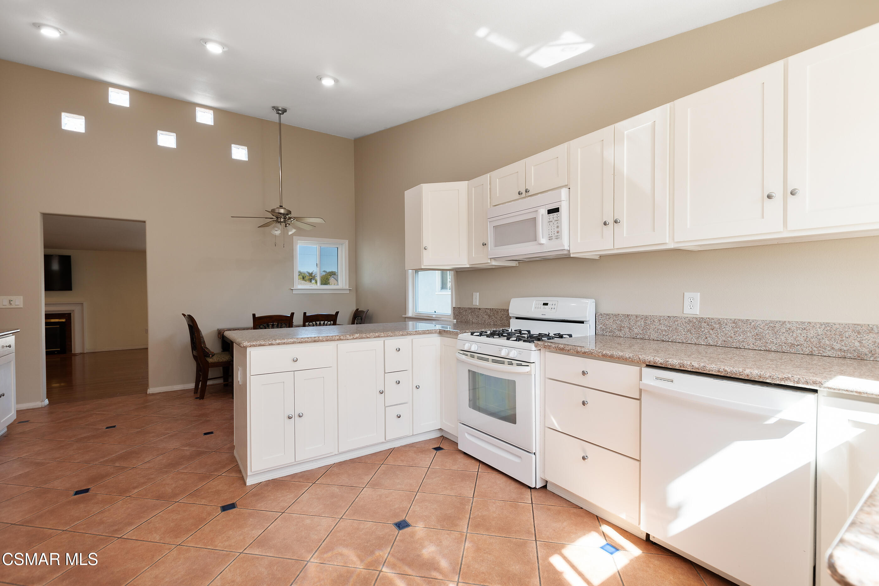 1204 Deodar Avenue Oxnard, CA 93030 - Photo 9 of 25 a kitchen with granite countertop white cabinets white stainless steel appliances with a sink and dishwasher