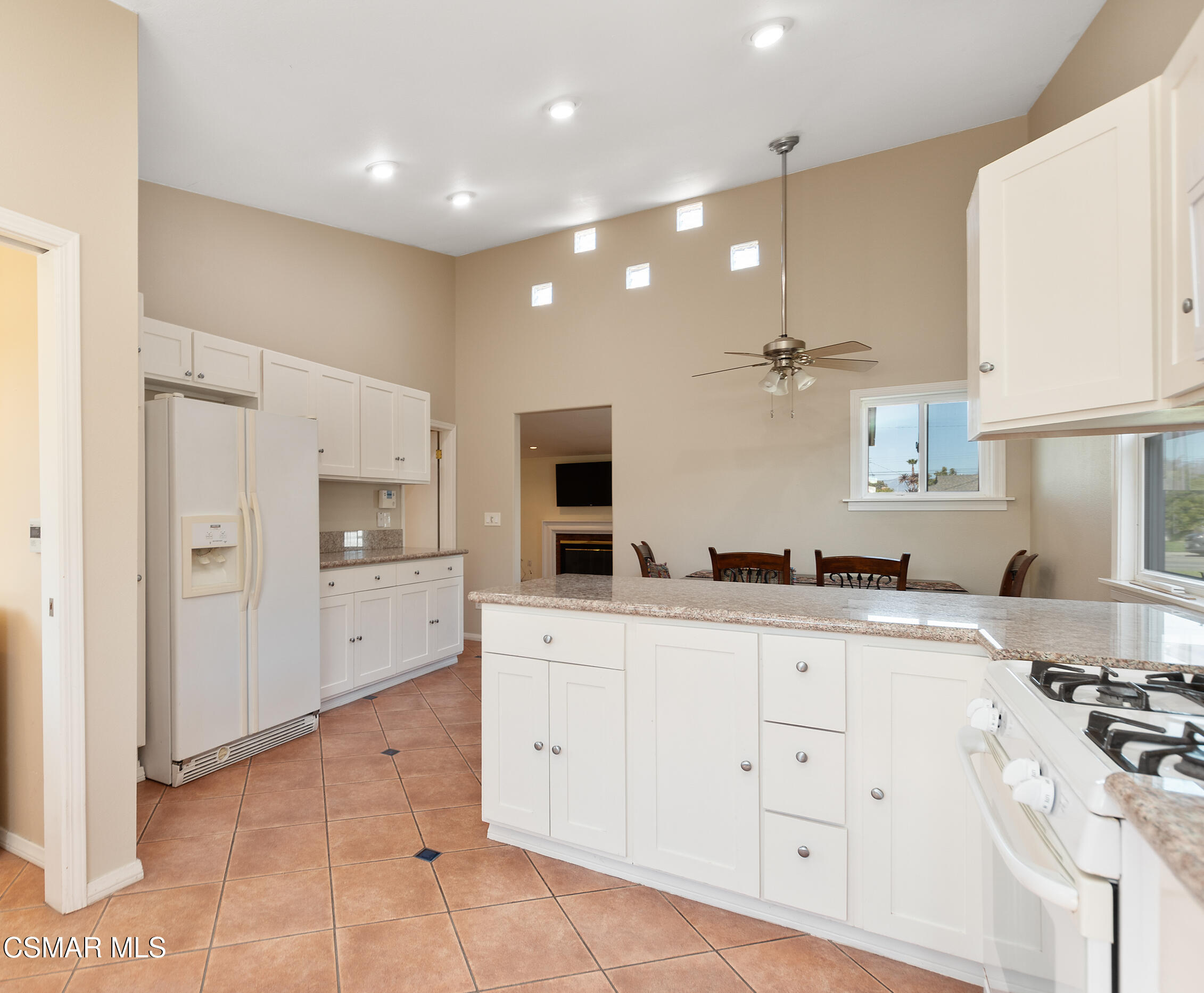 1204 Deodar Avenue Oxnard, CA 93030 - Photo 10 of 25 a large kitchen with stainless steel appliances a stove a sink a refrigerator and white cabinets with wooden floor