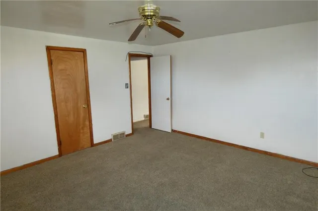 a view of a room with a ceiling fan