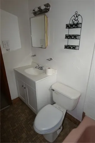 a white toilet sitting next to a bathroom sink