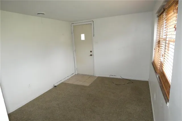 a view of an empty room and a window
