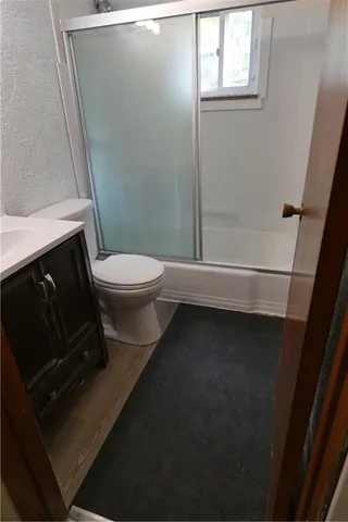 a bathroom with a toilet a sink and a shower