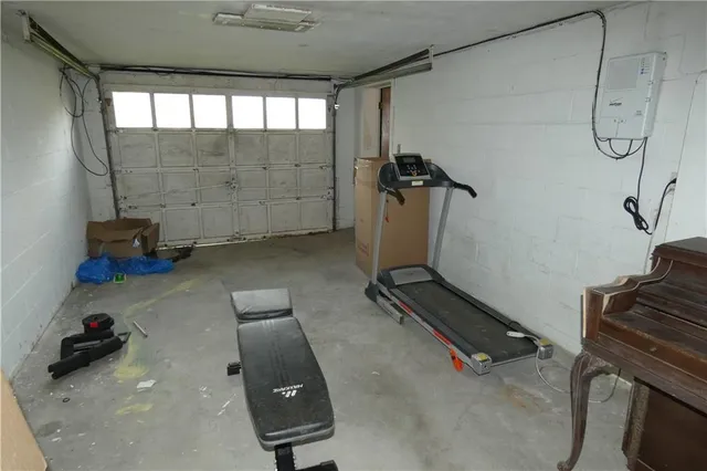a room with gym equipment and a shower