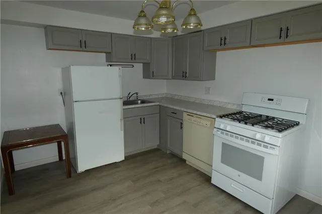 a kitchen with a stove a sink and a refrigerator