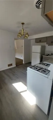 a stove top oven sitting inside of a kitchen