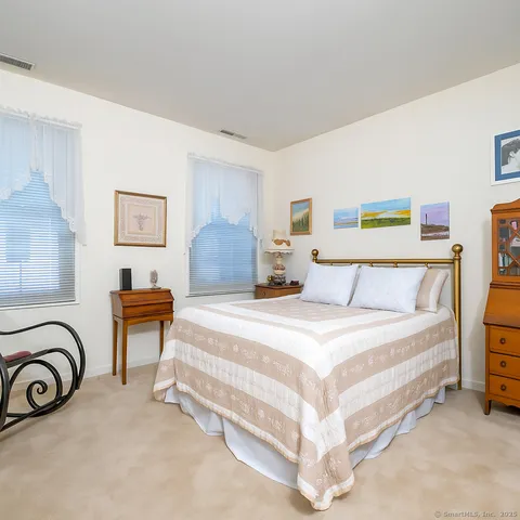 a spacious bedroom with a bed and a couch