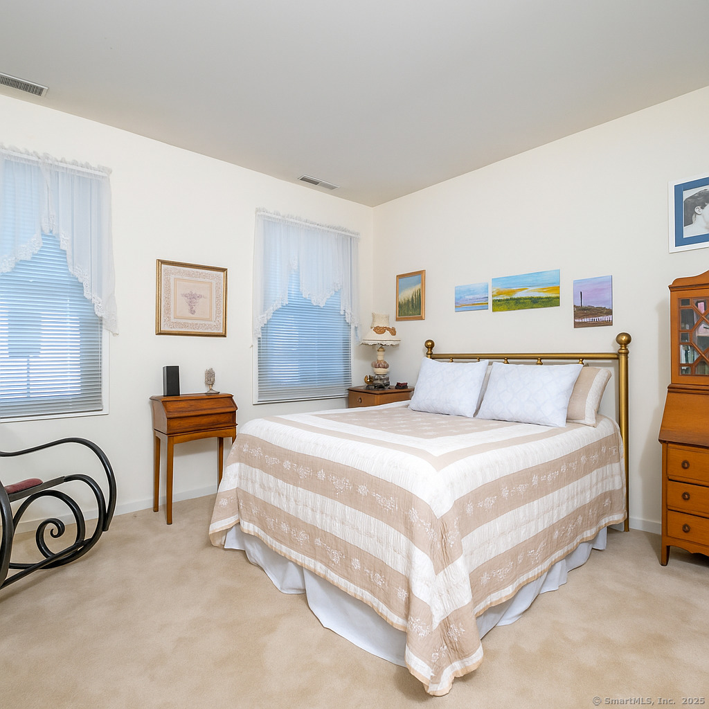 19 Prospect Ridge, Unit 14 Ridgefield, CT 06877 - Photo 18 of 36 a spacious bedroom with a bed and a couch