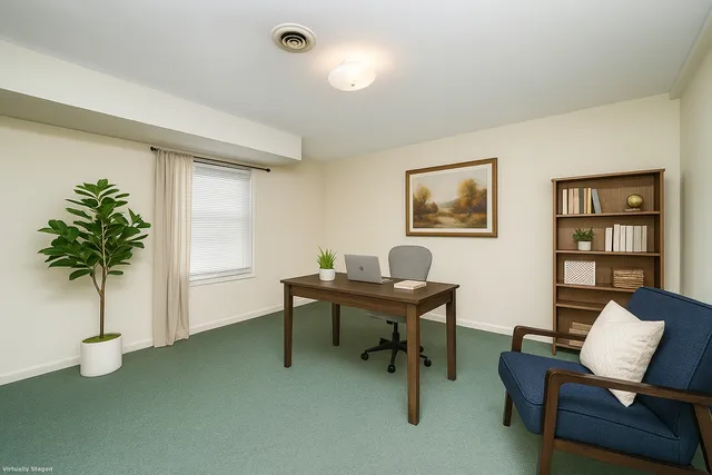 a work room with furniture and a potted plant