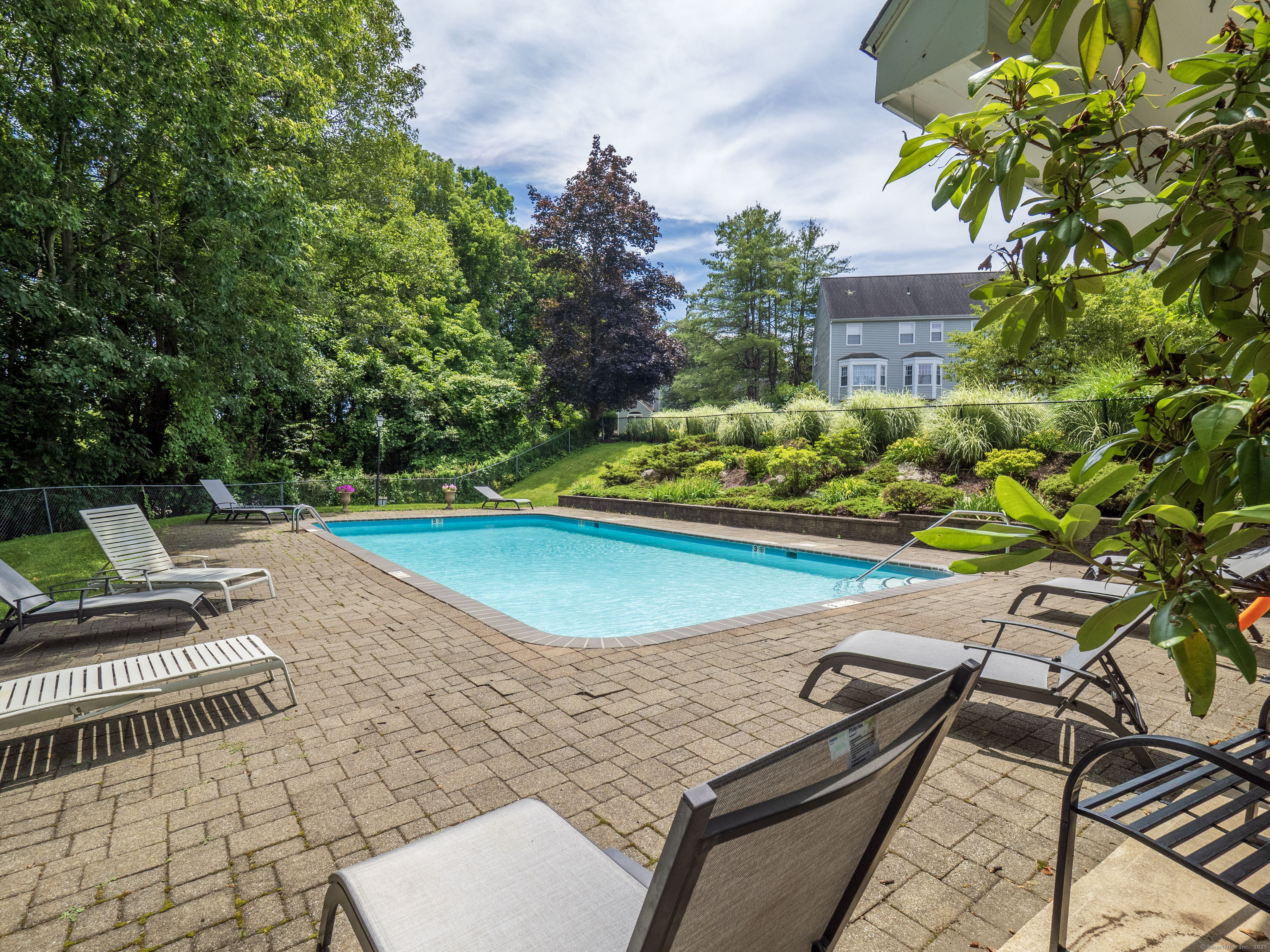 19 Prospect Ridge, Unit 14 Ridgefield, CT 06877 - Photo 25 of 36 a view of a patio with chairs and potted plants