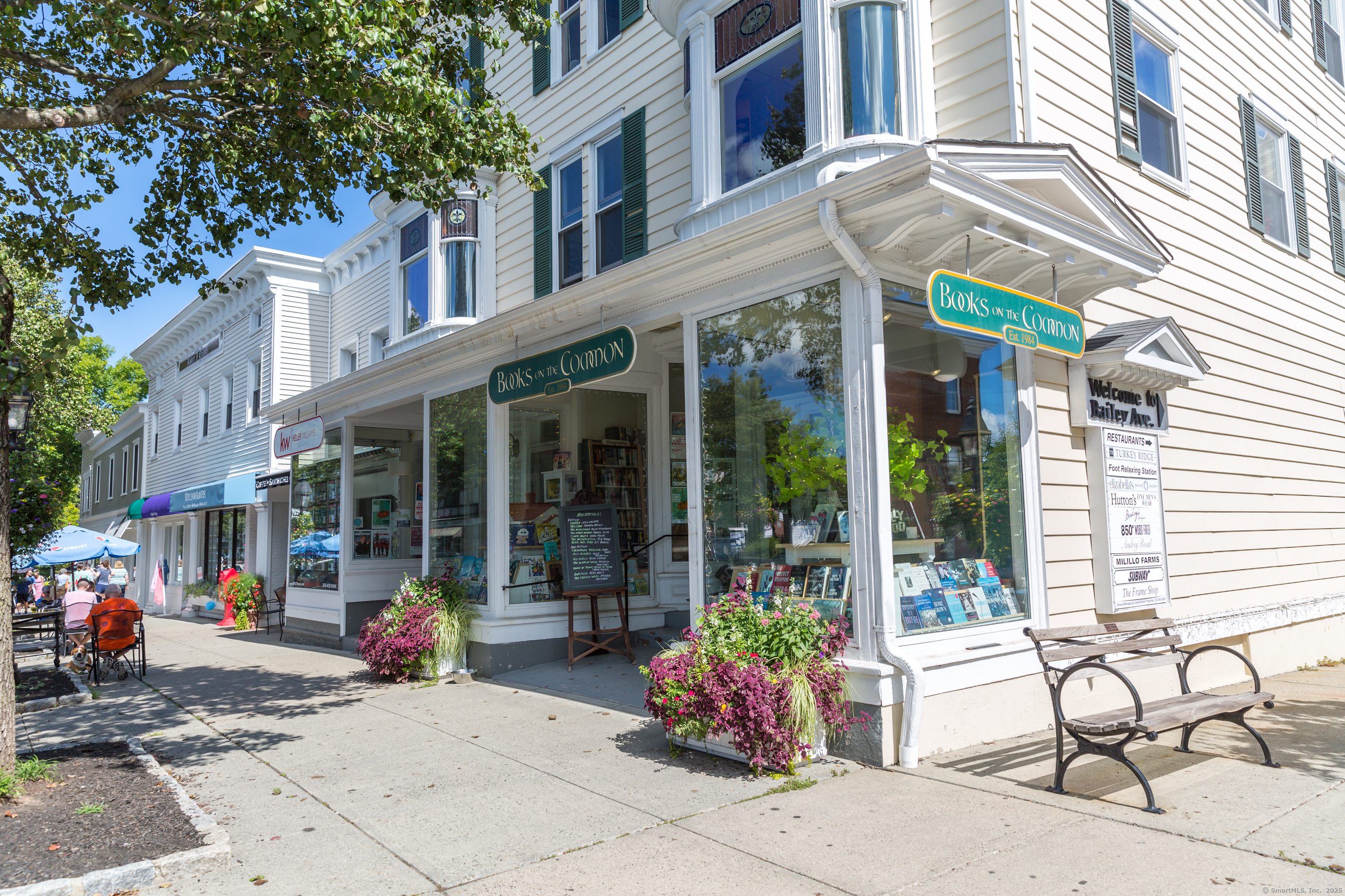 19 Prospect Ridge, Unit 14 Ridgefield, CT 06877 - Photo 28 of 36 a view of a brick building with a bench in front of building