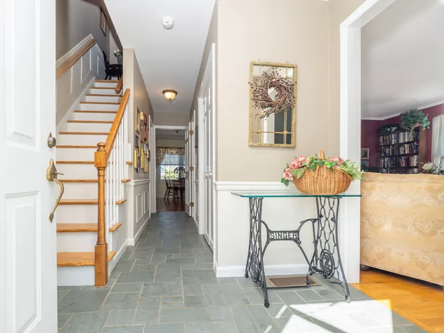 a view of entryway with furniture and wooden floor
