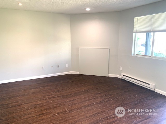 3915 Mason Loop Road Tacoma, WA 98409 - Photo 20 of 38 an empty room with wooden floor and windows