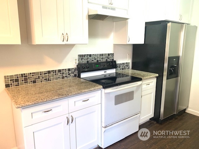 3915 Mason Loop Road Tacoma, WA 98409 - Photo 24 of 38 a kitchen with appliances cabinets and a counter top space