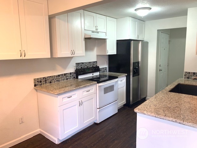 3915 Mason Loop Road Tacoma, WA 98409 - Photo 27 of 38 a kitchen with a appliances and cabinets