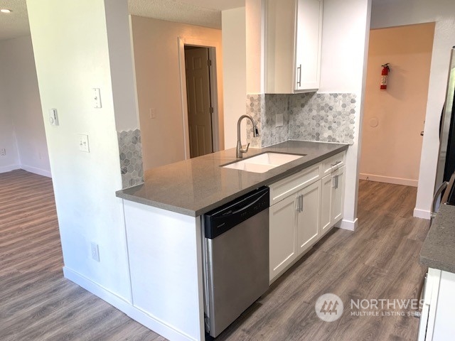 3915 Mason Loop Road Tacoma, WA 98409 - Photo 3 of 38 a kitchen with a sink and a refrigerator
