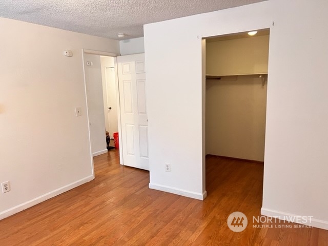 3915 Mason Loop Road Tacoma, WA 98409 - Photo 34 of 38 an empty room with wooden floor and closet